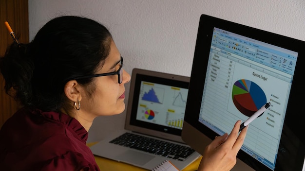 A detailed close-up of a teacher using an AI-powered dashboard to analyze student performance data. The dashboard displays various metrics, including learning progress, areas of strength, and areas needing improvement.