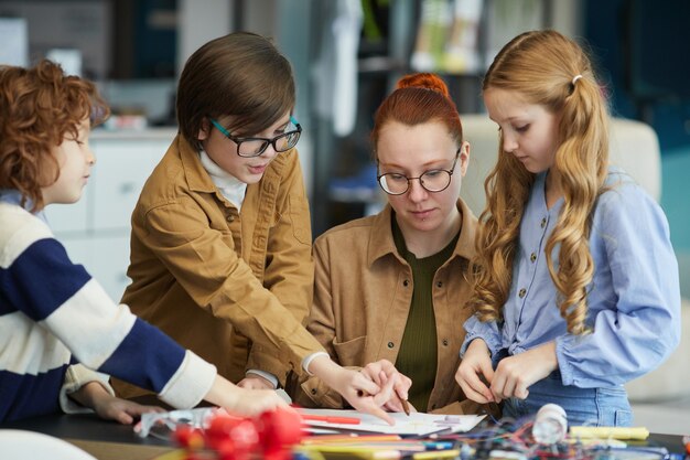 A group of teachers participating in a STEM professional development workshop, focusing on hands-on activities and collaborative learning.