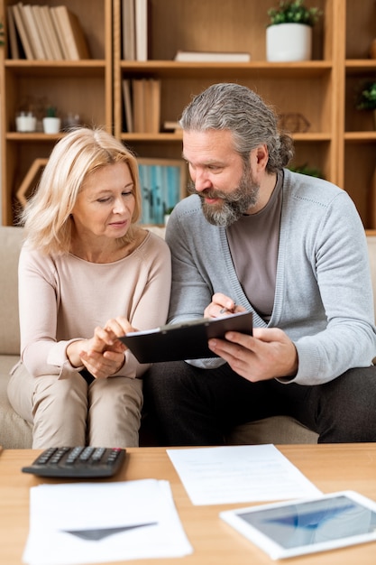 A professional financial advisor discussing HSA options with a young couple in a well-lit office. The focus is on healthcare savings and financial planning.