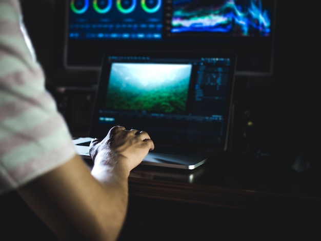 A close-up of a trader's hands working on a multi-monitor setup, displaying complex options chains and real-time market data. Capture the intensity and analytical nature of options trading.