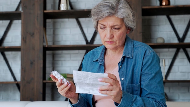 A senior woman with a concerned expression, looking at a bill. Soft lighting, focus on the woman's face and the bill.
