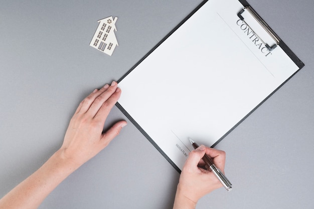 A close-up shot of an application form for a state affordable housing program. A pen is resting on top of the form, and a hand is visible filling it out.