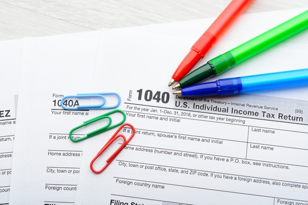 A close-up shot of a US tax form 1040, with a pen circling a section titled 