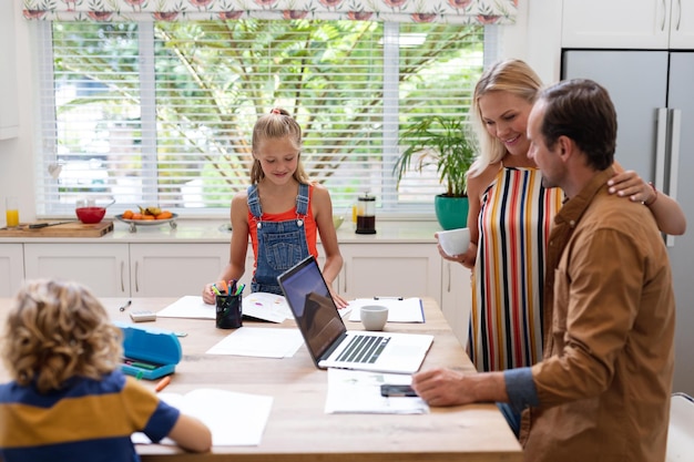 A family sitting at a table reviewing documents related to energy assistance programs, including applications and information brochures. The scene emphasizes the process of seeking help and understanding available resources.
