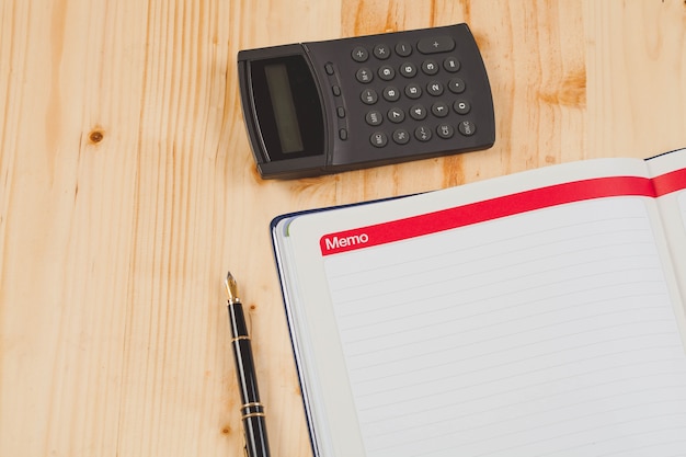 A close-up shot of a calculator, tax form, and pen on a desk. The calculator displays a significant tax savings amount.