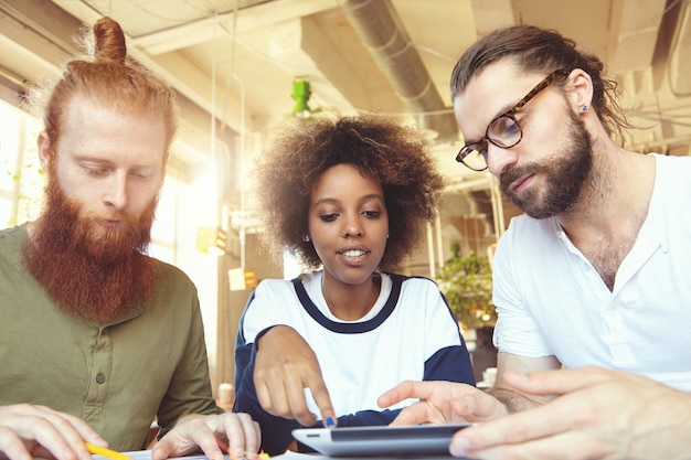 A diverse group of employees working collaboratively in a modern small business office. The atmosphere is productive and positive, highlighting the benefits of the Work Opportunity Tax Credit.