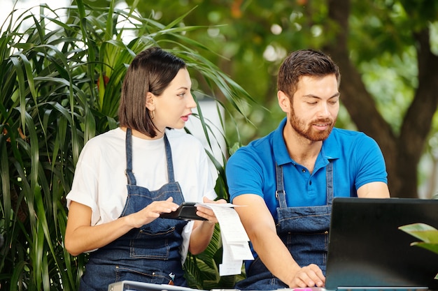 Two young summer employees working together in a retail setting, showcasing the youth and entry-level job aspects of the WOTC program.