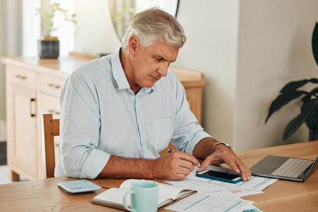 A person sitting at a desk reviewing documents related to health insurance plans and tax forms, with a calculator nearby, representing the process of assessing eligibility and applying for the HCTC.