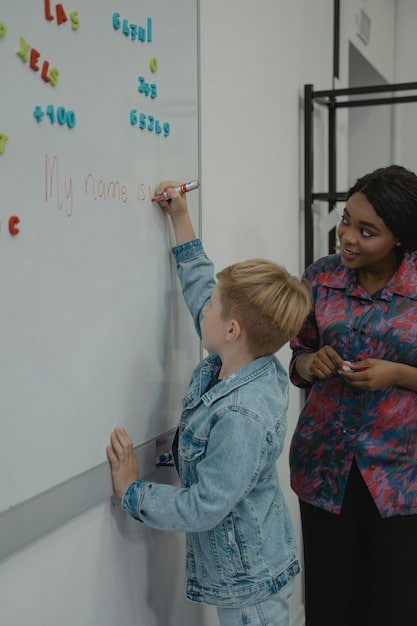 A teacher standing at the front of a classroom, enthusiastically explaining a math concept on a whiteboard. The students are actively engaged, raising their hands and participating in the discussion.