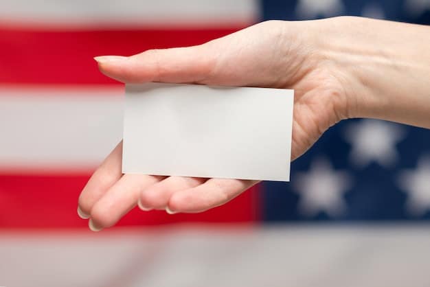 A close-up shot of a veteran's hand holding a Veterans Affairs (VA) healthcare card. The background is blurred but suggests a medical environment, possibly a doctor's office or hospital.