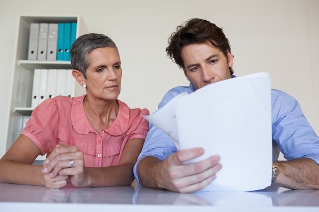 A family sitting at a table, reviewing documents related to health insurance. They appear to be engaged in a thoughtful discussion, highlighting the importance of understanding healthcare options.