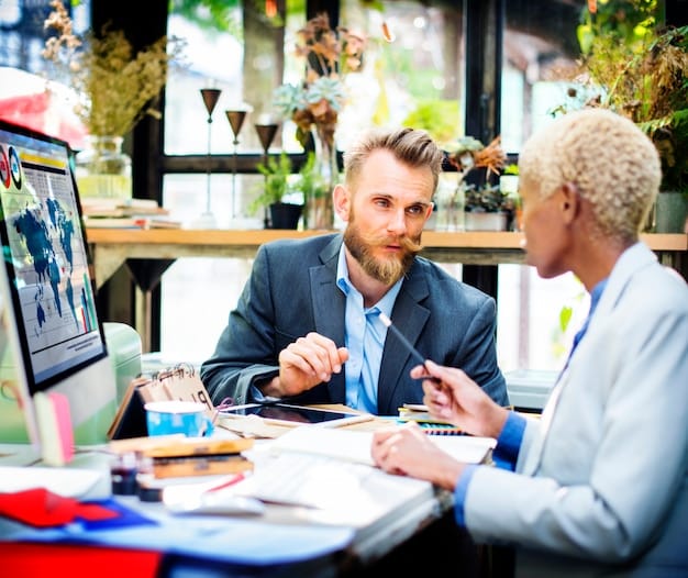 An advisor at a Small Business Development Center (SBDC) mentoring a small business owner, reviewing financial projections and business plans, demonstrating the personalized support available to entrepreneurs.