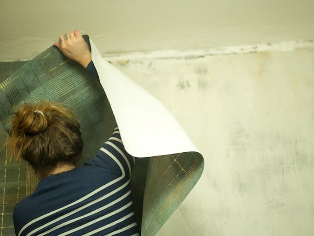 A close-up of a homeowner installing energy-efficient insulation in their attic, highlighting the materials and the process of upgrading home insulation.