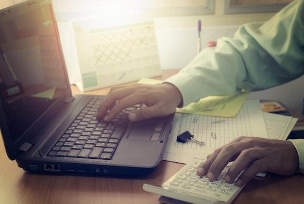 An individual carefully working on their tax return, utilizing online resources to ensure accurate EITC calculations, underling the importance of correct filing.