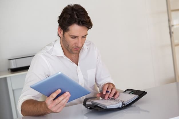 A person reviewing tax documents with a tablet displaying an overview of advance payments and reconciliation processes.