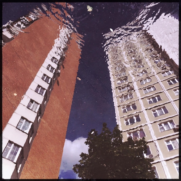 A split image illustrating the contrast between a bustling film set in a major city (representing states with high tax credits) and a similar film set in a rural area (representing states benefiting from federal incentives).