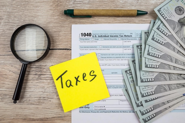 A close-up of a U.S. tax form highlighting the section for the Earned Income Tax Credit. A calculator and pen are placed beside the form, symbolizing careful calculation and preparation. The form is clean and organized, suggesting a straightforward process.