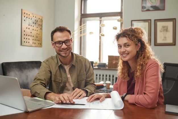 A close-up image of a smiling tax preparer sitting across a table from a young couple, helping them with their tax forms. The atmosphere is friendly and supportive.