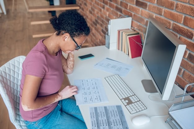 A teacher sitting at their desk, looking stressed while reviewing student loan paperwork, with stacks of bills and financial documents surrounding them.