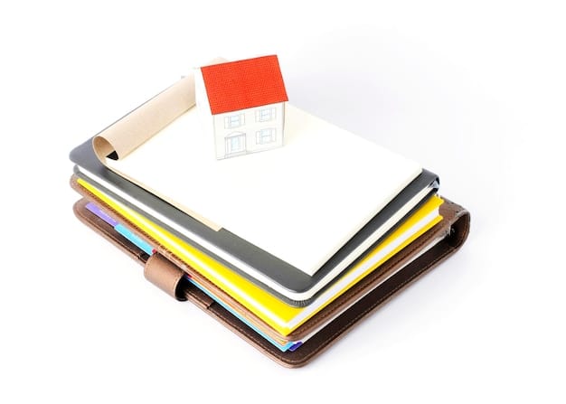 An organized folder containing receipts, invoices, and product certifications for energy-efficient home improvements, emphasizing the importance of documentation.